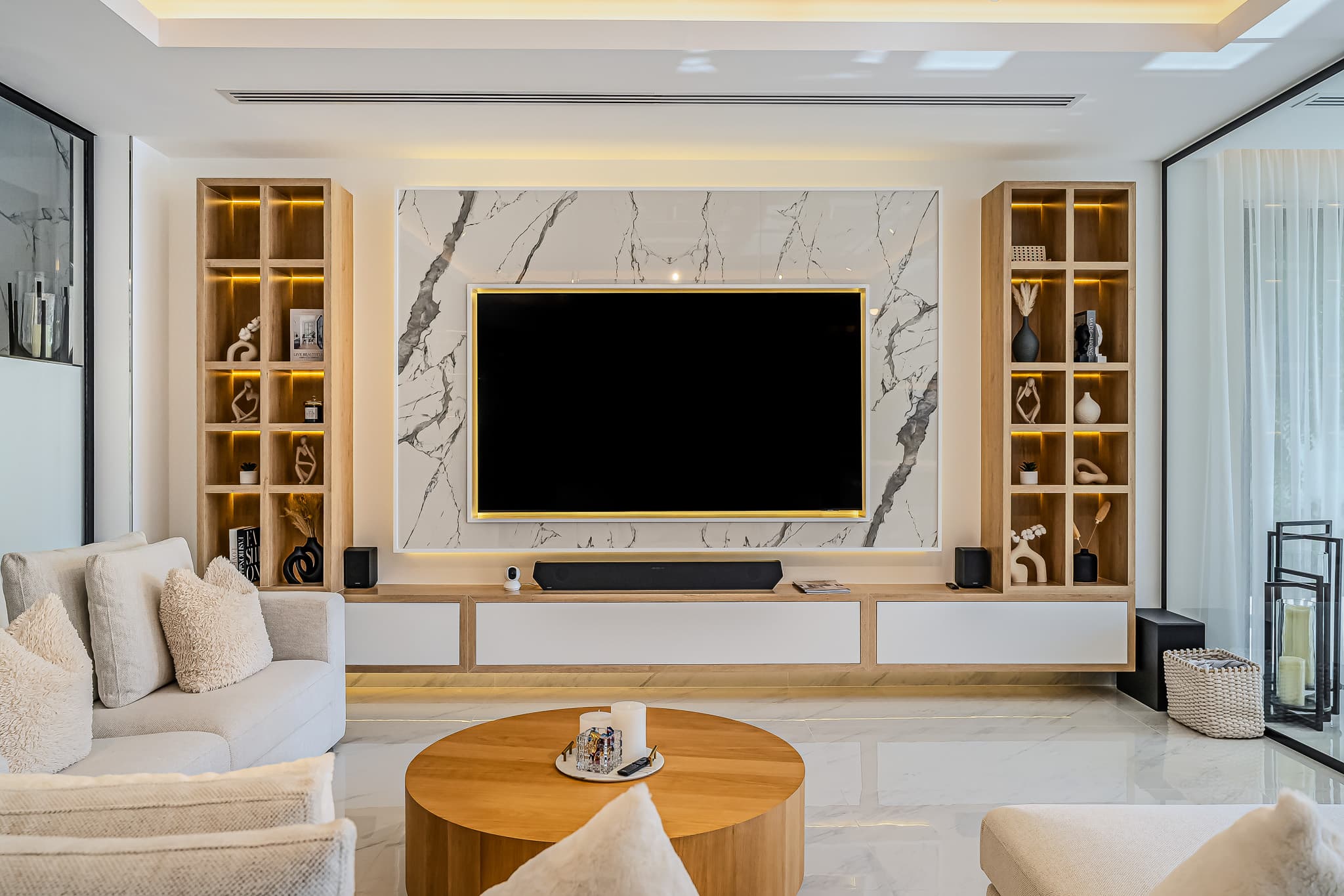 Luxury villa redevelopment Dubai - entertainment wall with marble and wood accents