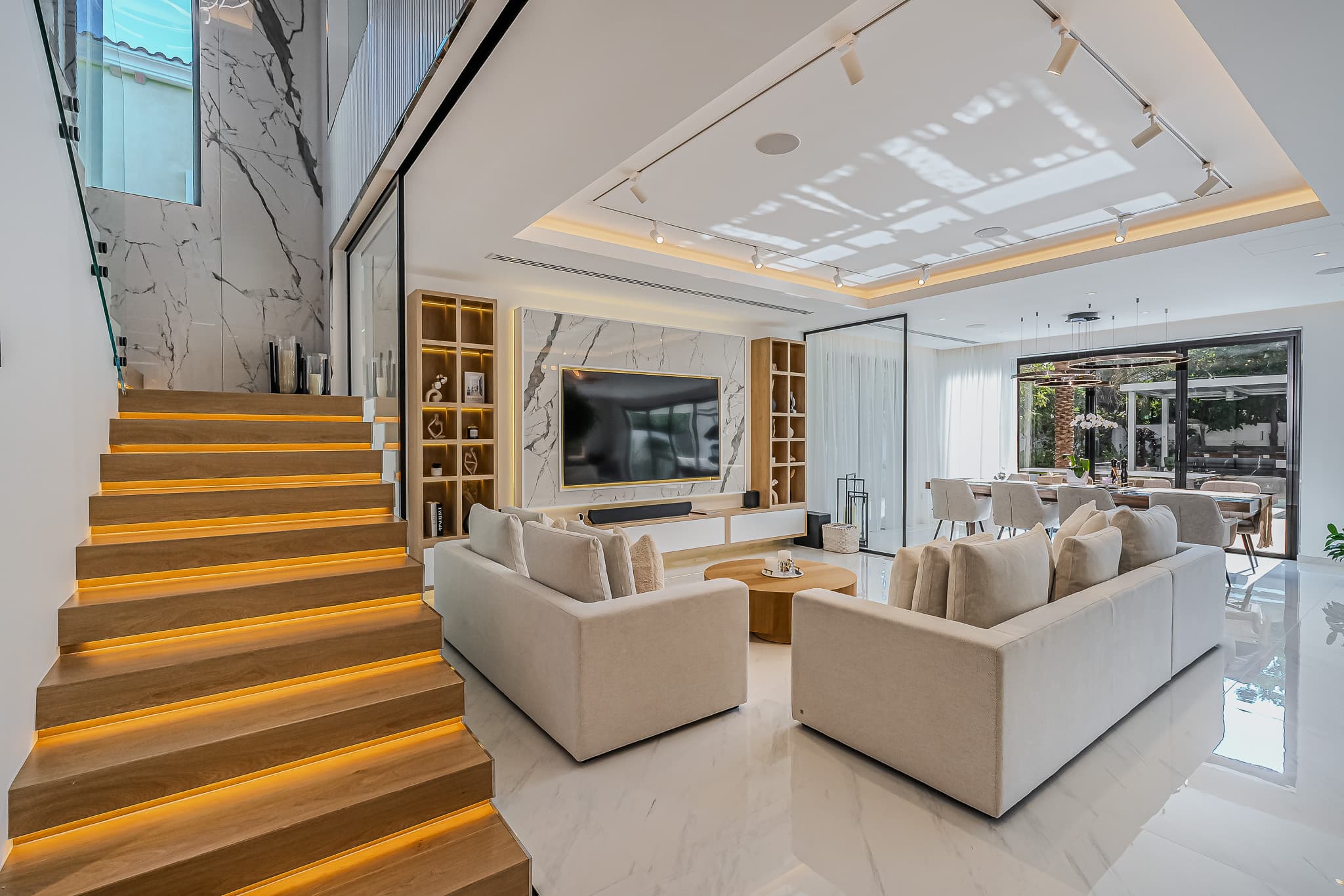 Dubai villa interior renovation - living room with LED-lit stairs and marble finishes