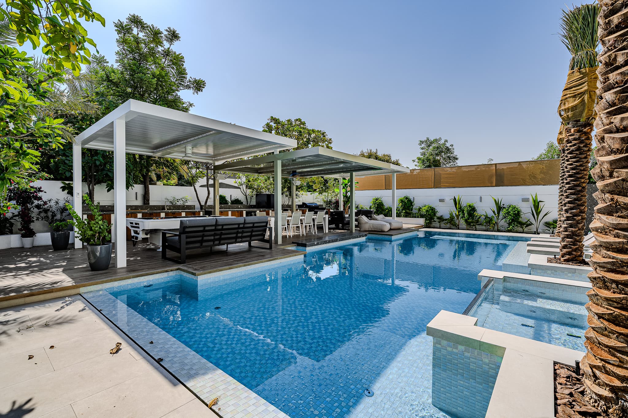 Villa pool renovation Dubai - modern pergola and outdoor living design