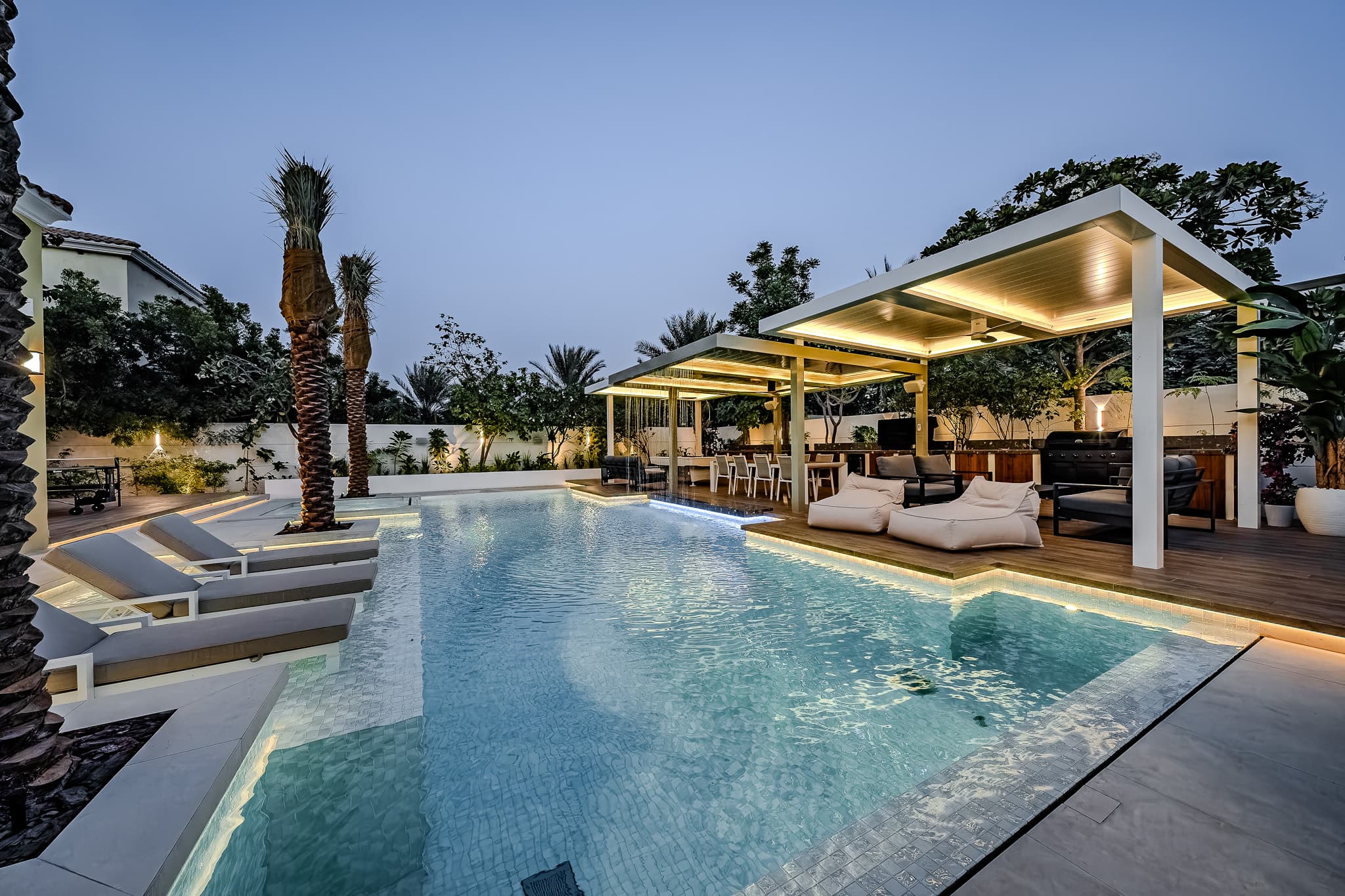 Dubai villa renovation - twilight pool with ambient lighting and landscape design